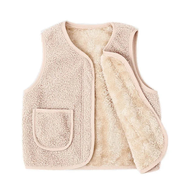 Side profile of a child in a lambswool vest, a classic and warm choice for winter toddler fashion.