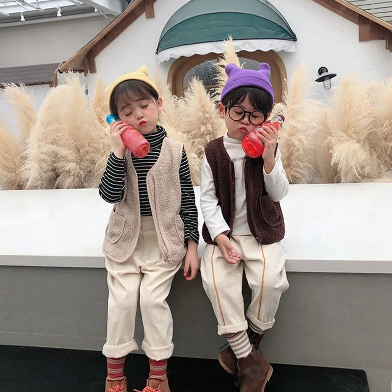Child wearing a high-quality lambswool vest, designed for warmth and comfort in winter children's fashion.