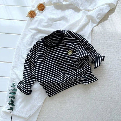 Toddler in a striped cotton long sleeve shirt, perfect for casual, all-season kids' wear.