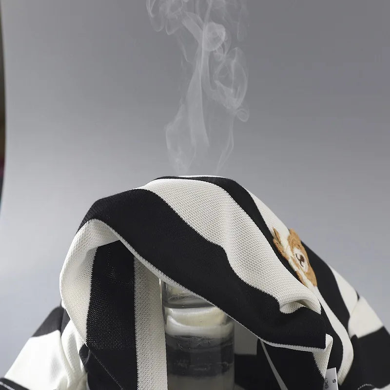Front view of a folded kids' striped t-shirt and matching shorts set for toddlers, playground clothes.