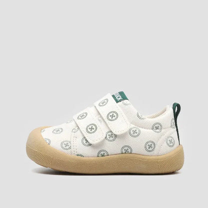 Close up of textured canvas fabric on a purple toddler sneaker, emphasizing breathability.
