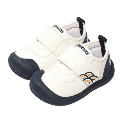 Close-up of a blue canvas toddler sneaker, showcasing breathable fabric and secure hook-and-loop closure.
