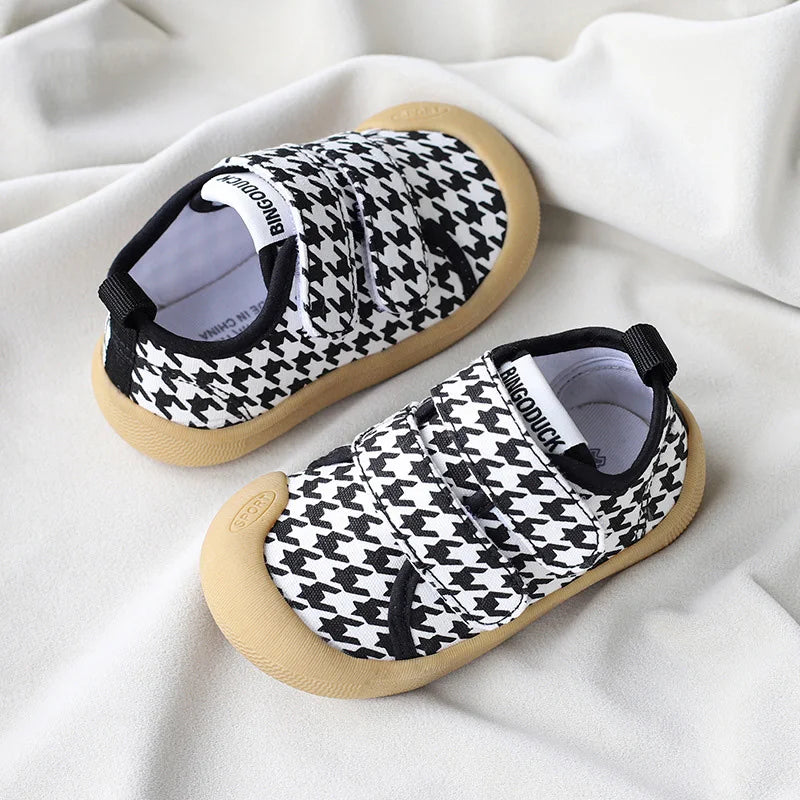 Pair of colorful kids' breathable canvas sneakers with non-slip soles, ideal for new walkers.