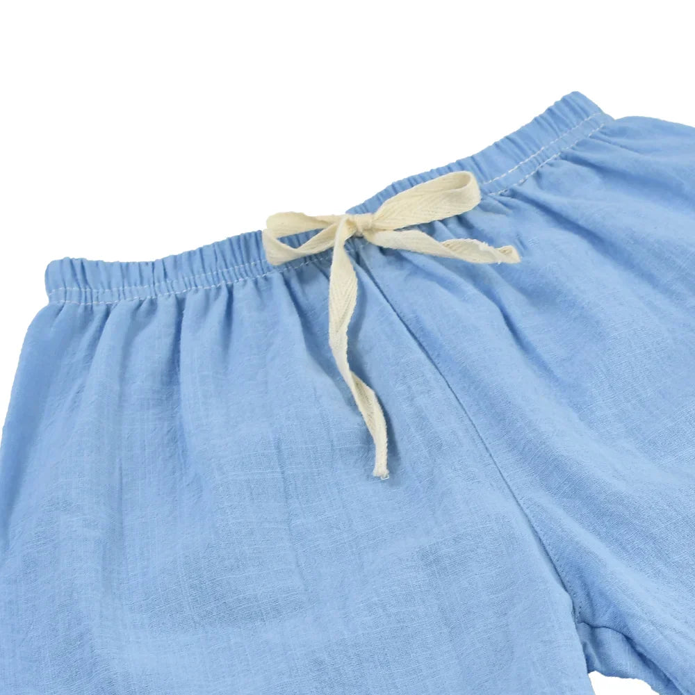 Kids' red cotton-linen shorts with elastic waist, ideal for active summer play.