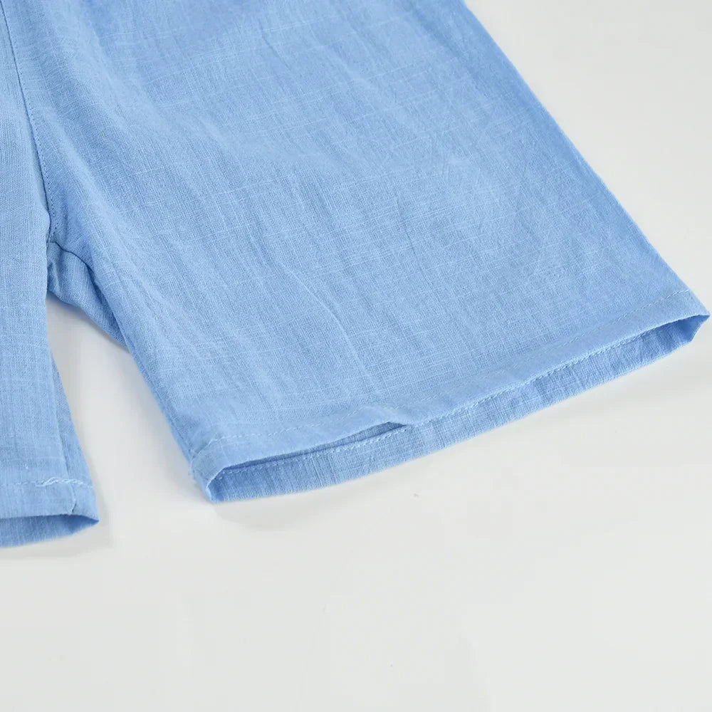 Close-up of the breathable cotton-linen fabric on kids' summer play shorts, soft texture.