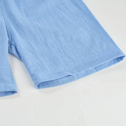Close-up of the breathable cotton-linen fabric on kids' summer play shorts, soft texture.
