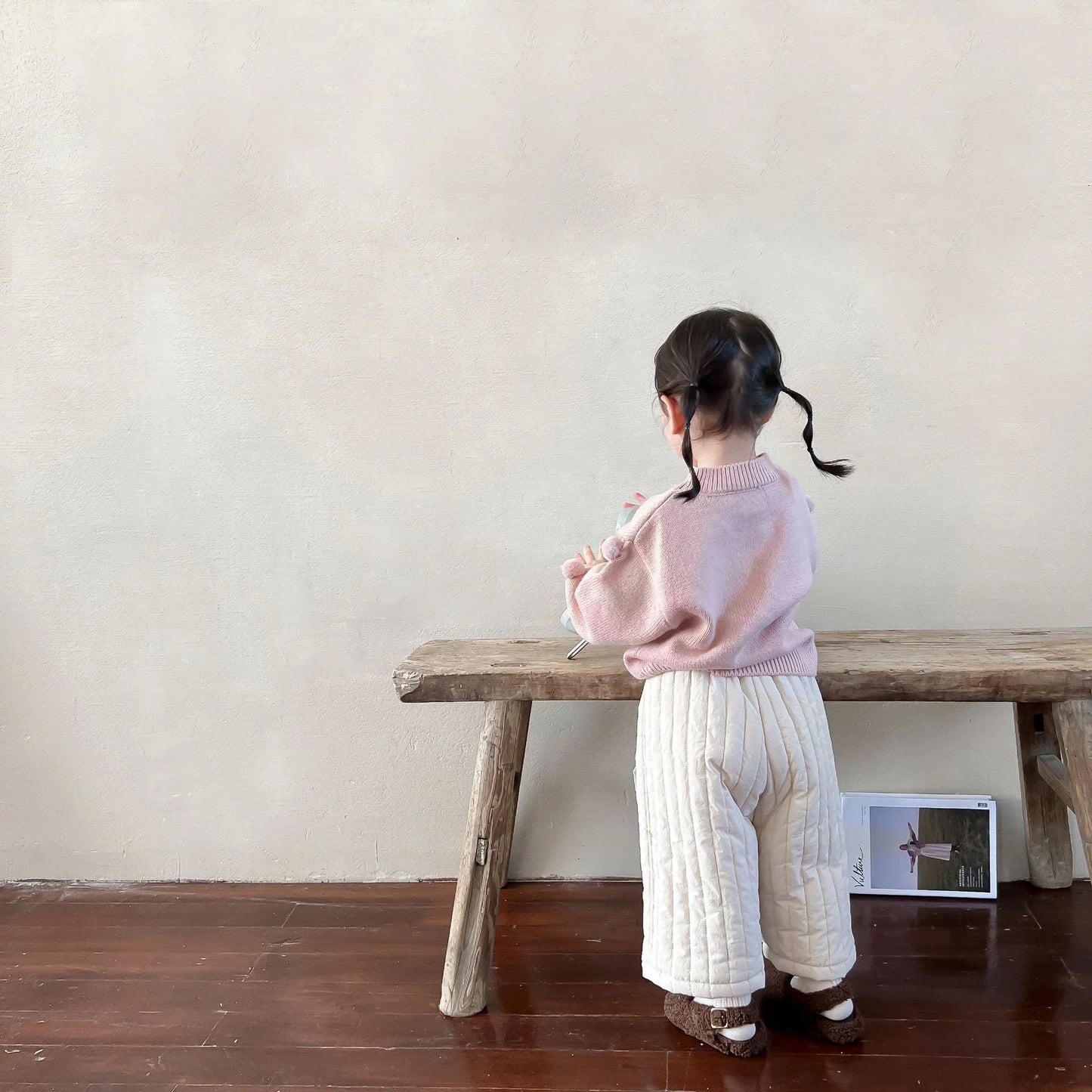 Child playing while wearing durable cotton harem pants with a comfortable elastic waist.