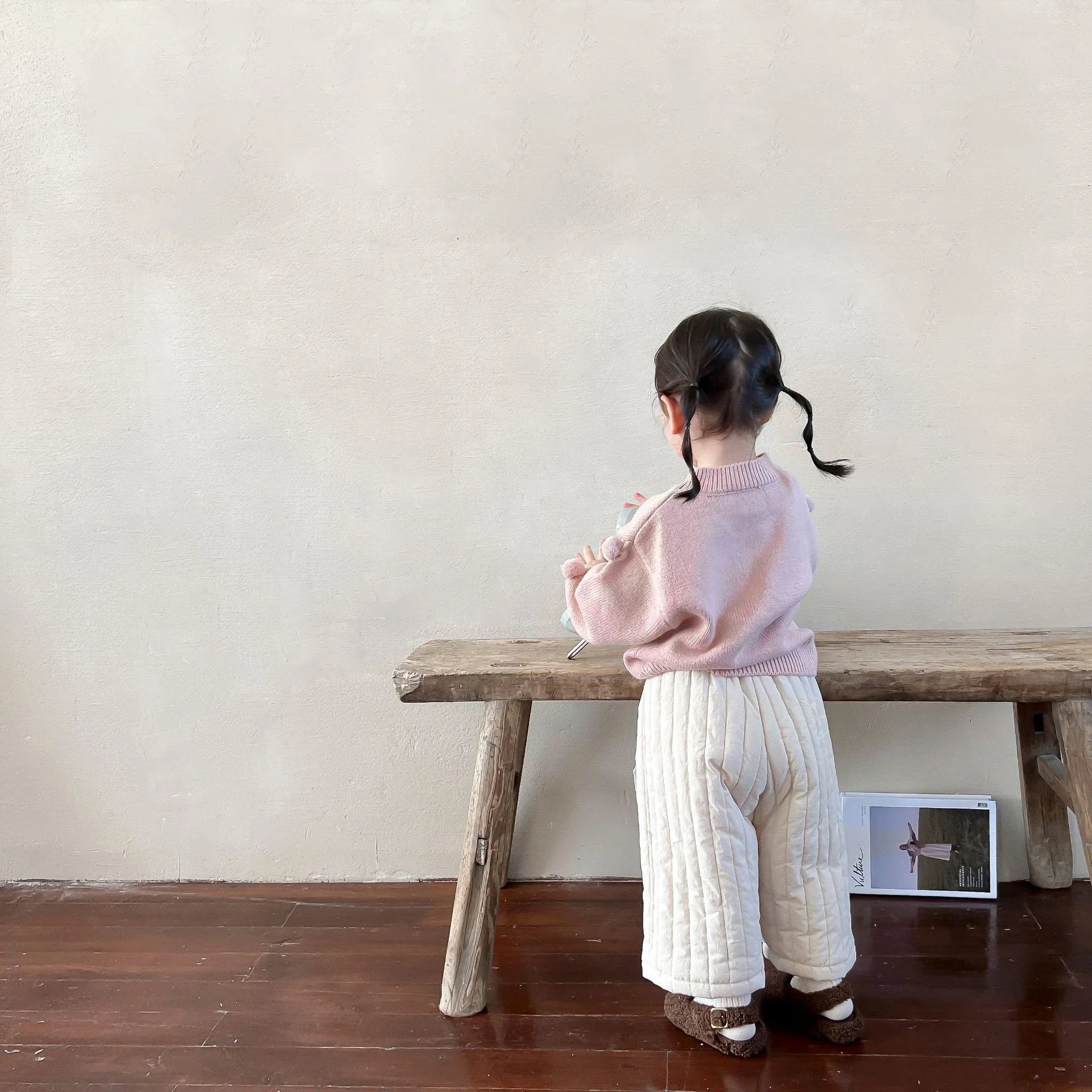 Child playing while wearing durable cotton harem pants with a comfortable elastic waist.