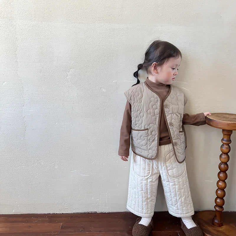 Close-up of the elastic waistband on kids' cotton harem pants, displaying quality stitching.