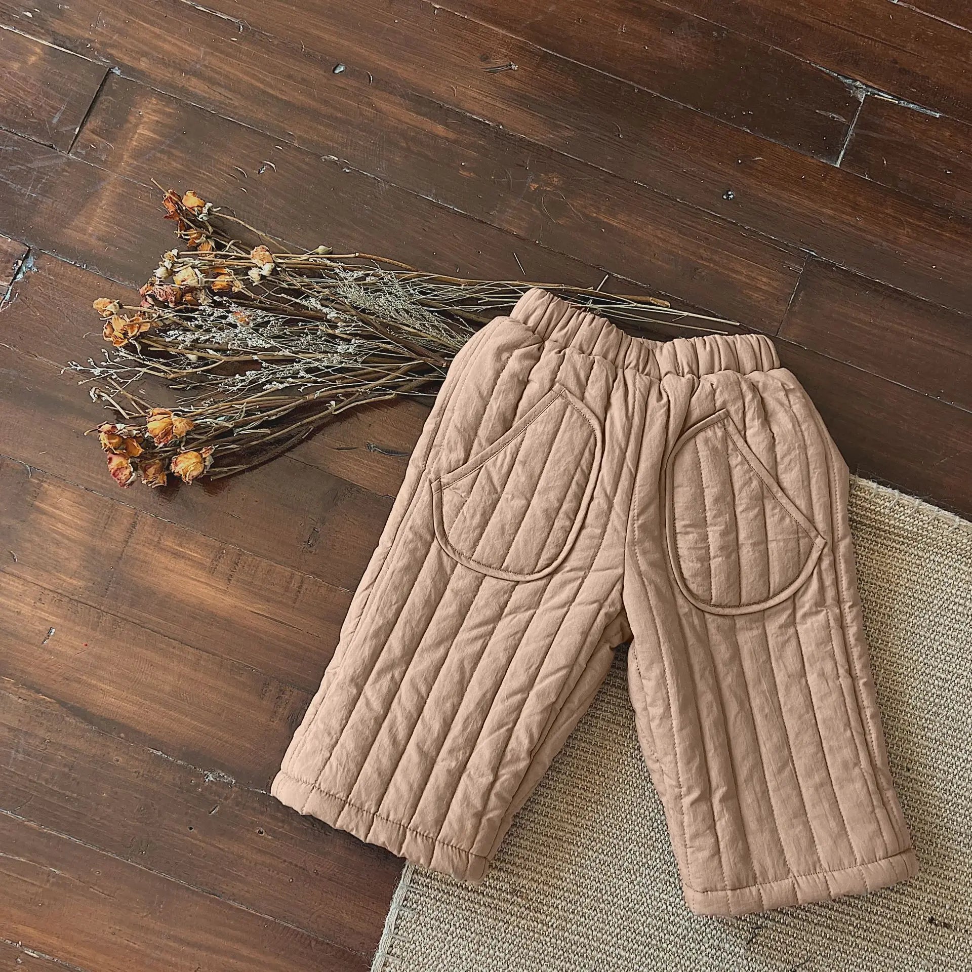 Baby wearing stylish and comfortable cotton harem pants, suitable for everyday infant fashion.