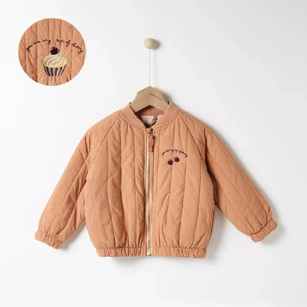 Child reaching out in a purple cotton padded winter jacket. Freedom of movement kids' outerwear.