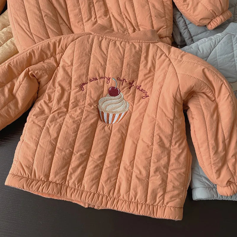Group of colorful kids' winter jackets, cotton padded, for toddlers. Assorted cozy outerwear collection.