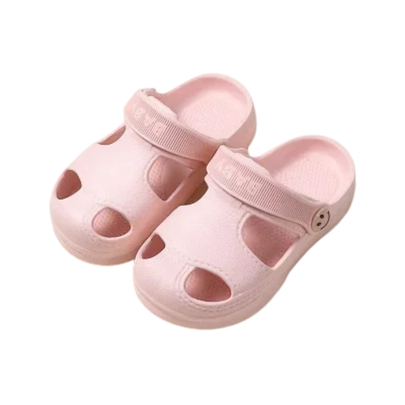 Child's feet wearing green non-slip EVA sandals, splashing in a shallow puddle