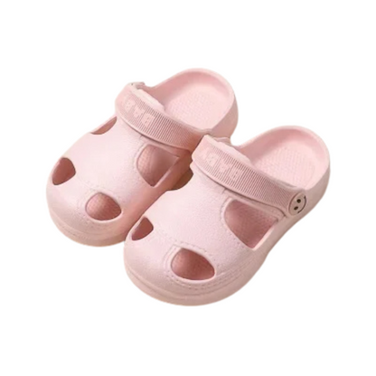 Child's feet wearing green non-slip EVA sandals, splashing in a shallow puddle
