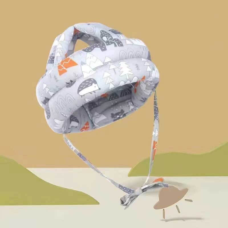 Front view of a baby wearing a safety headguard hat, designed to protect against falls during toddler development