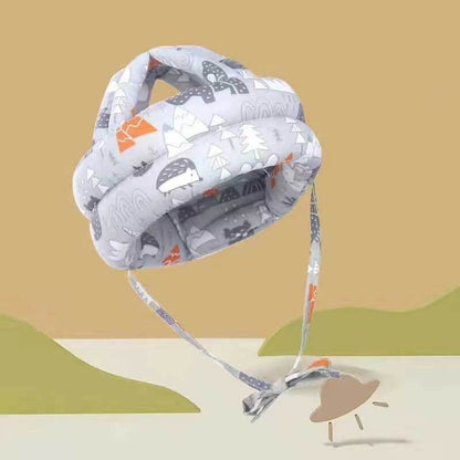 Front view of a baby wearing a safety headguard hat, designed to protect against falls during toddler development