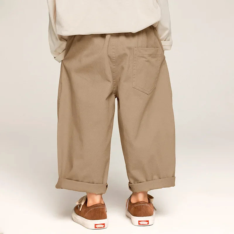 Stack of folded kids' wide leg cotton pants in various colors: pink, blue, olive, soft material