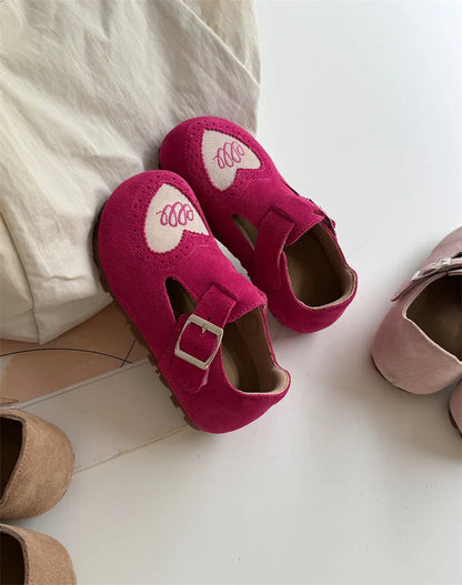 Assortment of colorful children's leather barefoot shoes, all with flexible soft soles.