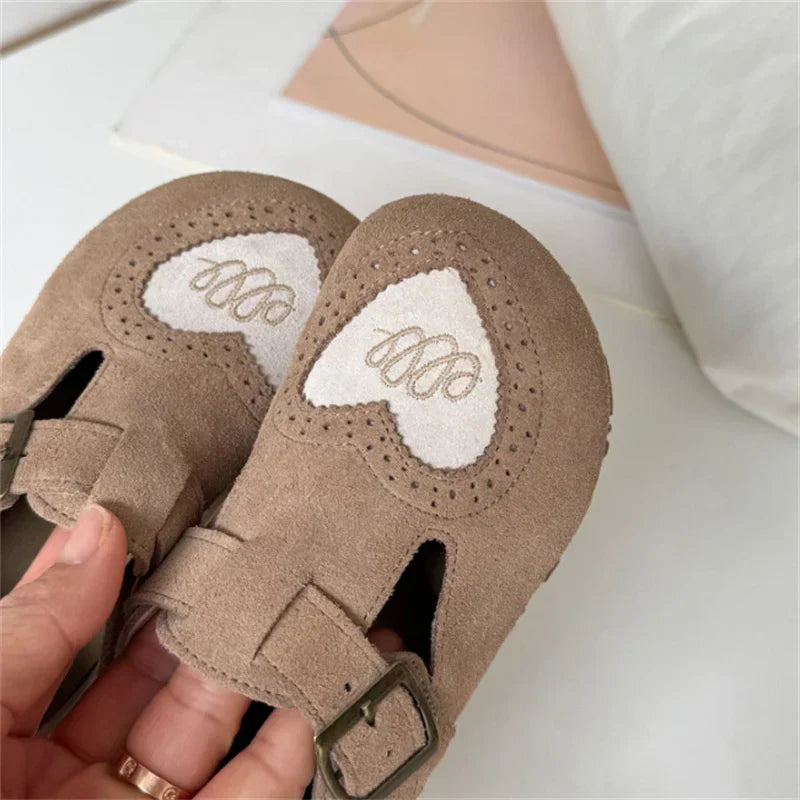 Pair of natural walking kids' leather barefoot shoes with soft, durable soles.