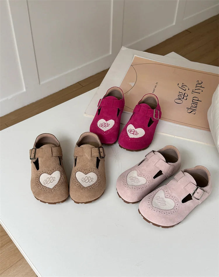 Front view of children's leather barefoot shoes with soft soles and simple velcro strap.