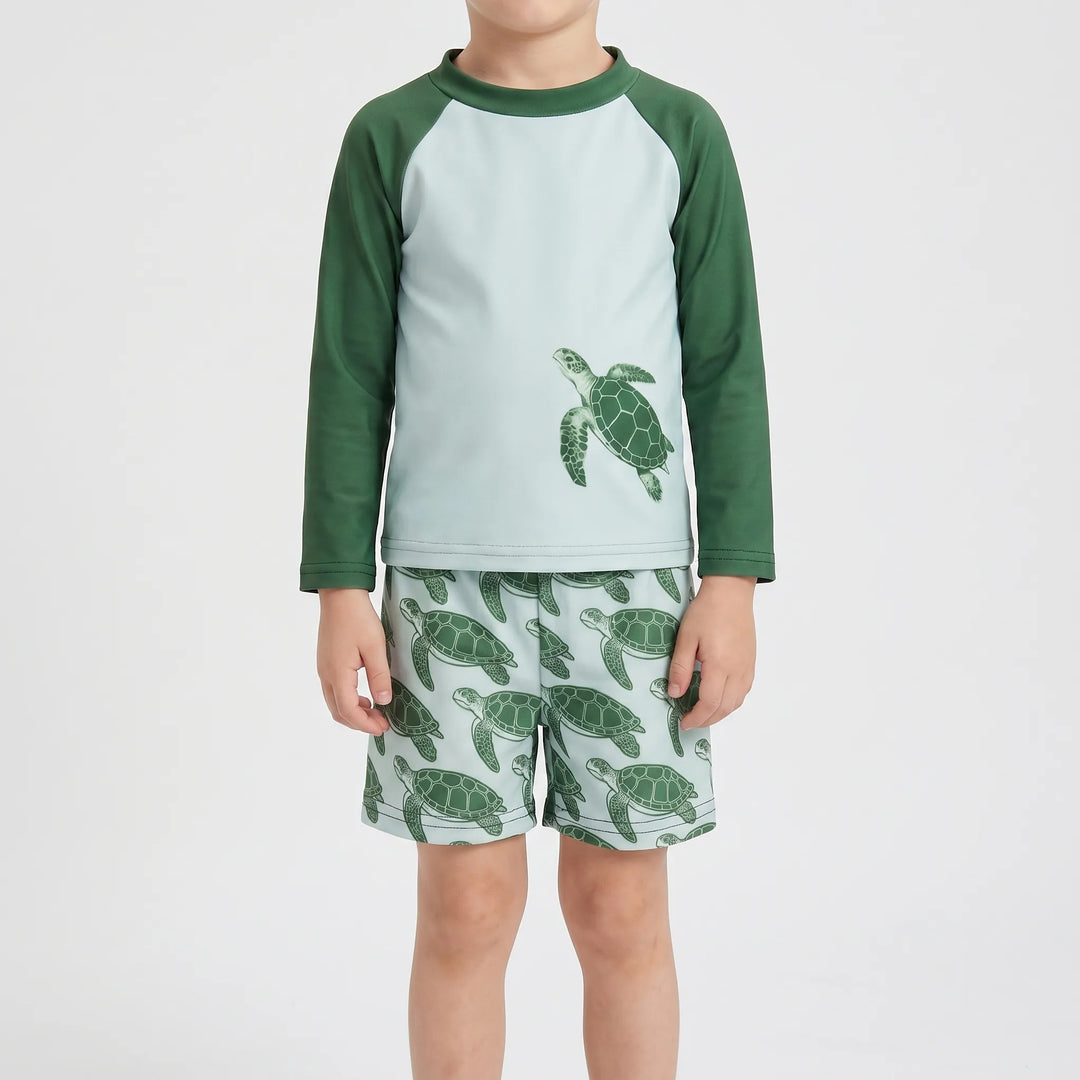 Close-up of toddler rash guard swim set in tortoise print. Long sleeves offer UPF 50+ sun protection for kids' beachwear.