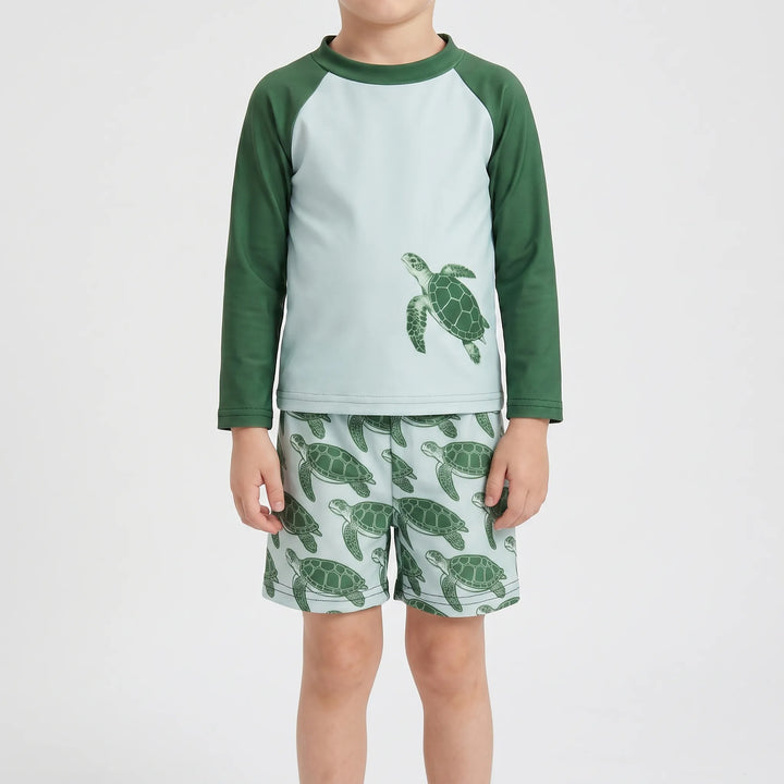 Close-up of toddler rash guard swim set in tortoise print. Long sleeves offer UPF 50+ sun protection for kids' beachwear.