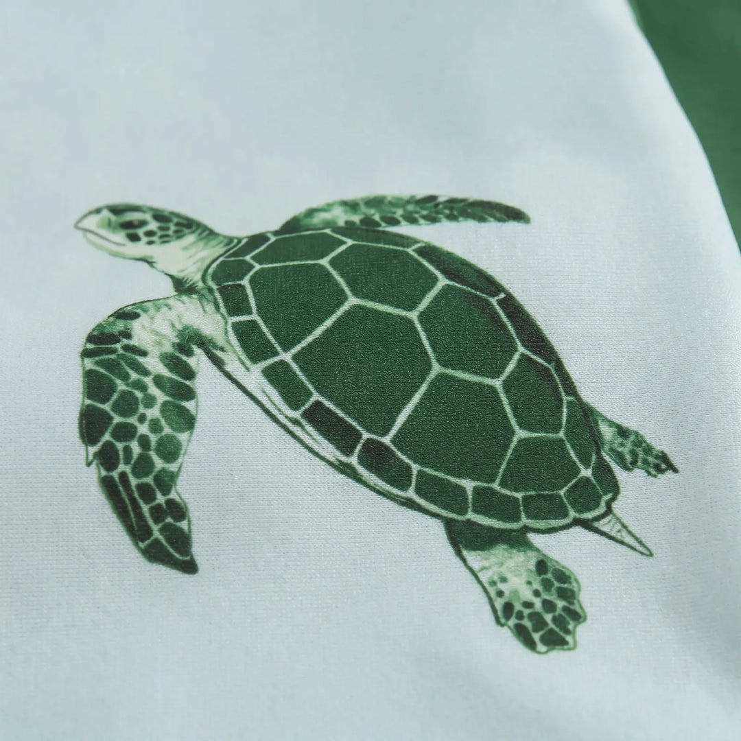 Kids long-sleeve rash guard swim set in tortoise print, perfect for active toddlers. Offers excellent sun protection for summer play.