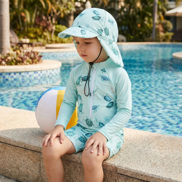 Toddler long-sleeve swimsuit & matching sun protection hat. Ideal for kids' summer water play.