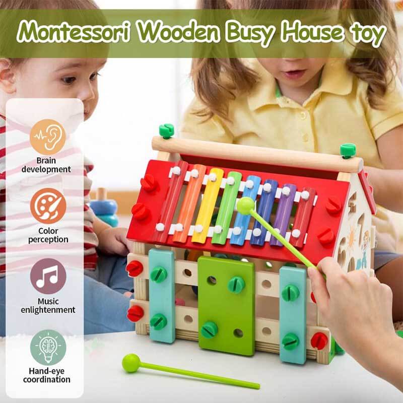 Close-up of a toddler's hand interacting with the fine motor skill components of a Montessori Wooden Activity House.