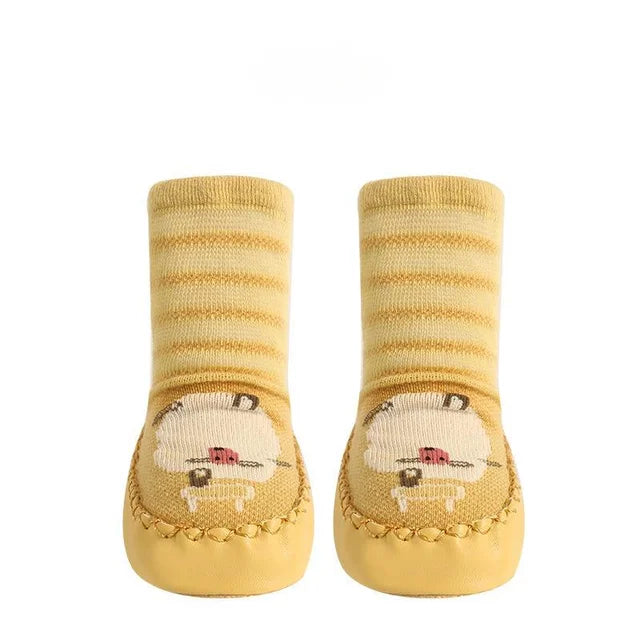 Toddler non-slip socks in a bright yellow with a cute lion print, soft baby footwear