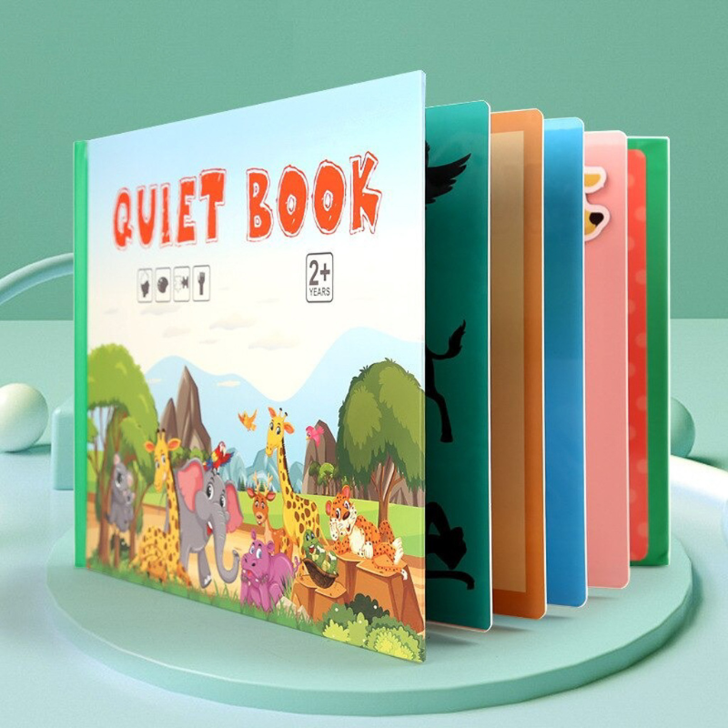 Toddler playing with buckle closure on an educational quiet book, a fun way to develop motor skills.