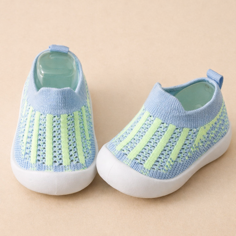 Toddler walking on grass in stylish gray non-slip play sneakers
