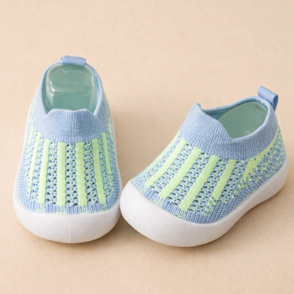 Toddler walking on grass in stylish gray non-slip play sneakers