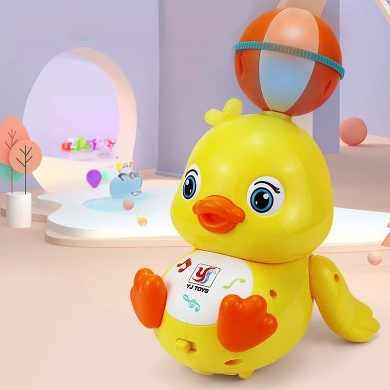 Toddler playing with an interactive spinning duck toy, featuring lights and sounds for child development
