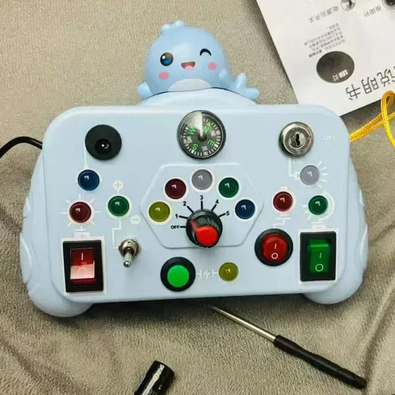 Close-up of a child's hand activating a button on an educational light & sound activity board