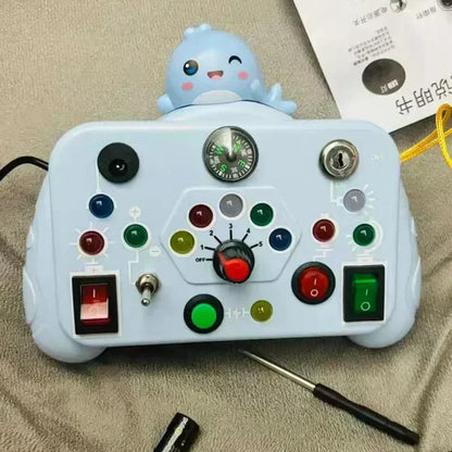 Close-up of a child's hand activating a button on an educational light & sound activity board