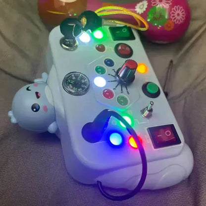 Kids' educational activity board featuring various lights, sounds, and interactive elements