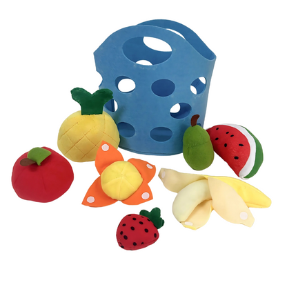Happy toddler carrying a felt market basket filled with soft, safe pretend play produce for learning.