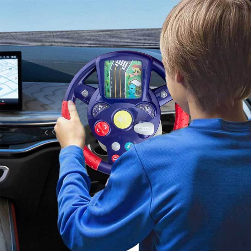 Close-up of a child's hands gripping an interactive steering wheel toy with colorful buttons.