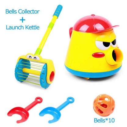 Side profile of a toddler focused on collecting bell balls from the activity toy