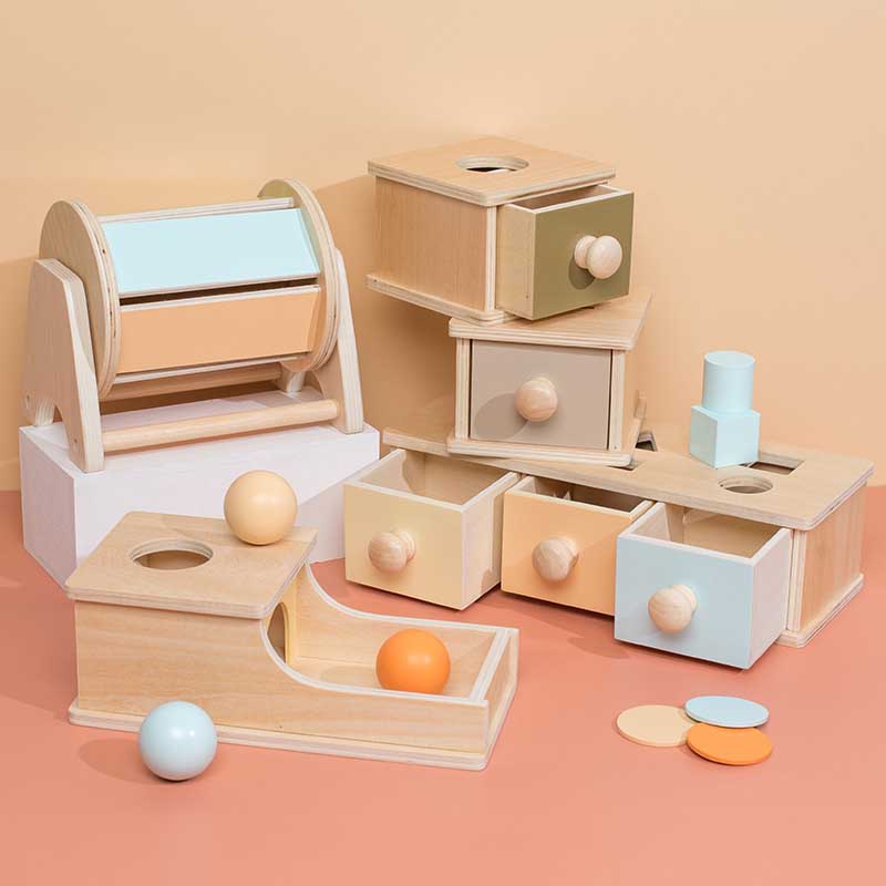 Toddler playing with Montessori wooden educational activity box, developing fine motor skills