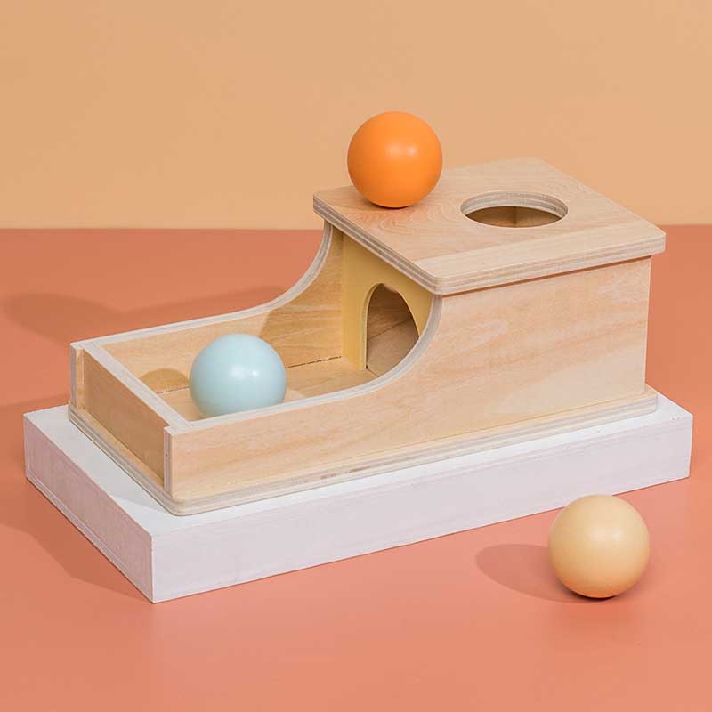 Close-up of a toddler's hand engaging with a wooden educational toy, developing coordination