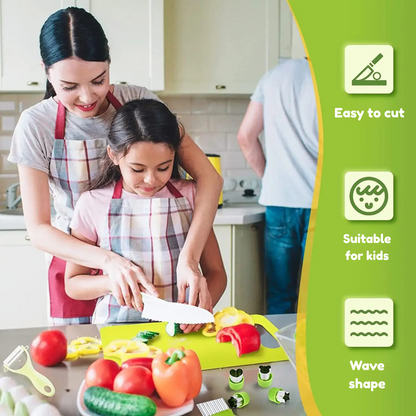 Colorful plastic vegetables and fruits with a safe wooden knife on a cutting board from a kids' kitchen playset