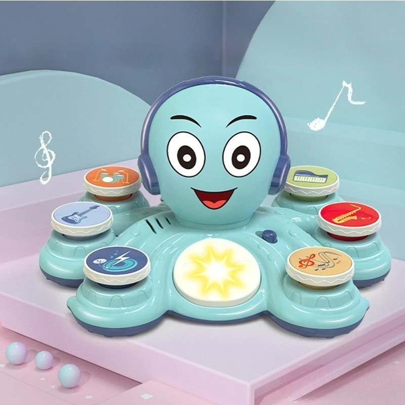 Toddler playing with Octobeats musical octopus, stacking colorful rings on sensory toy.