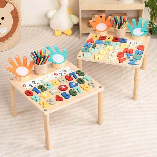 Toddler playing with wooden interactive learning table; teaching math & alphabet skills.