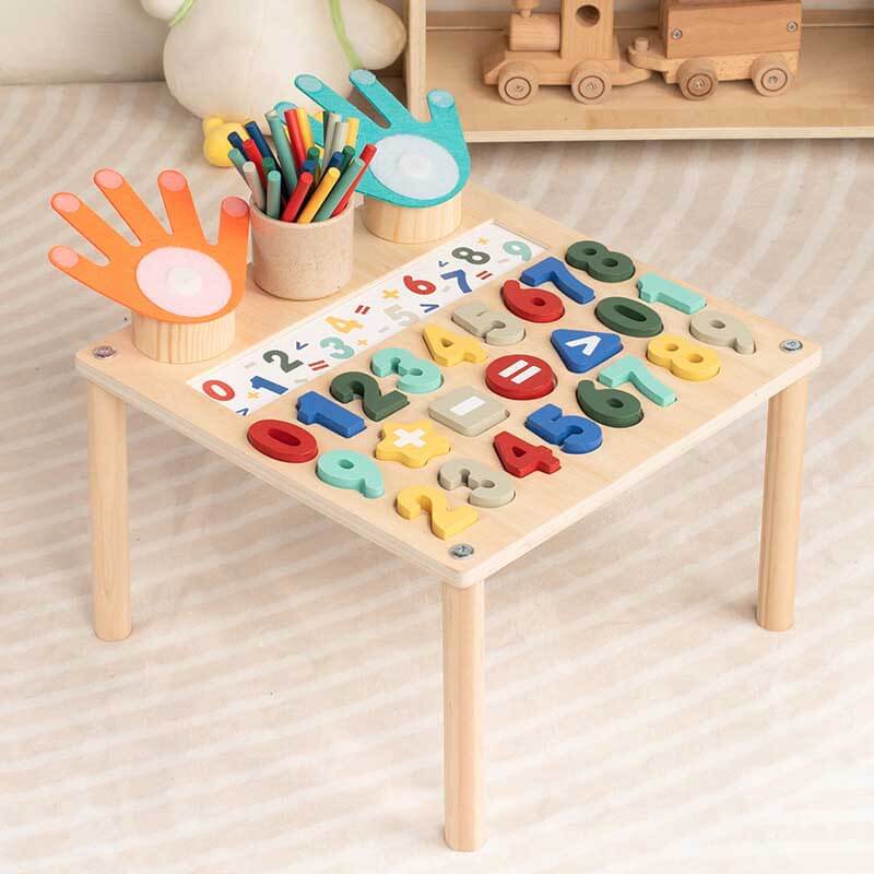 Top-down view of a wooden activity table designed for children's math and alphabet learning.