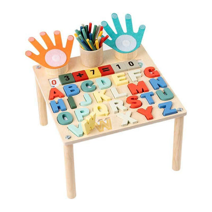 Smiling child enjoying an educational game on a wooden interactive learning table, early education.