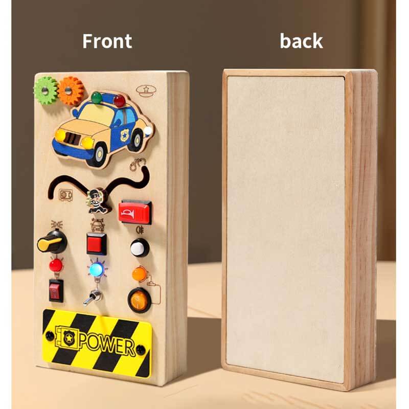 Overhead view of a wooden busy board, showing diverse switches for toddler exploration