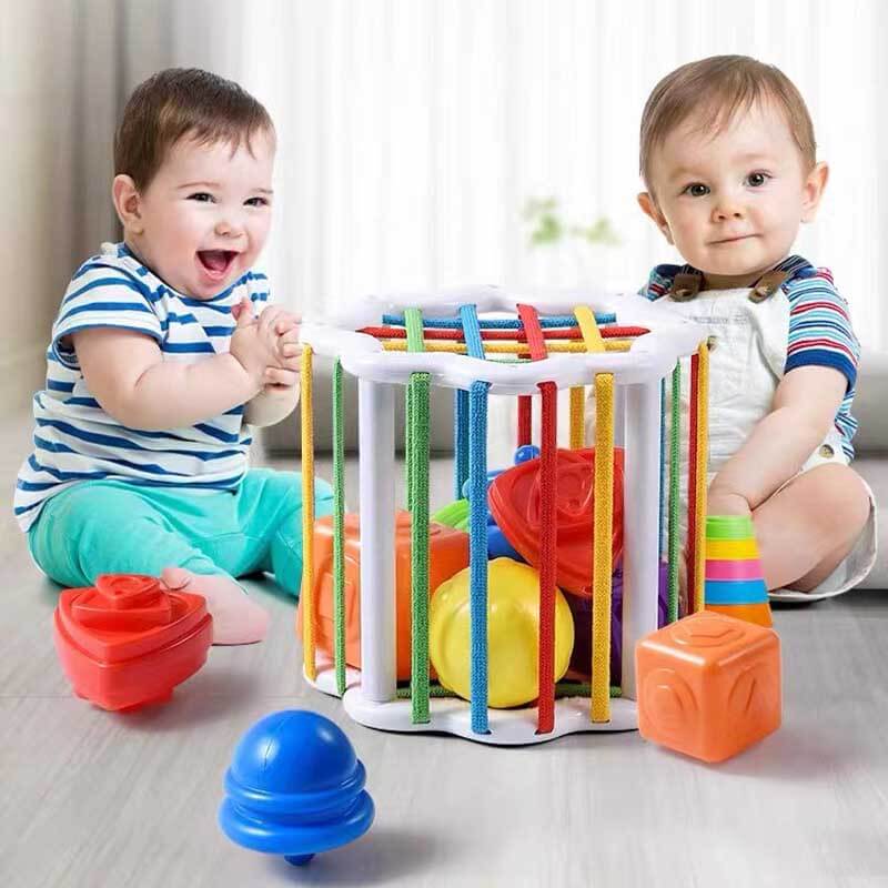 Sensory shape sorter with rainbow blocks, designed to boost toddler fine motor skills and learning.