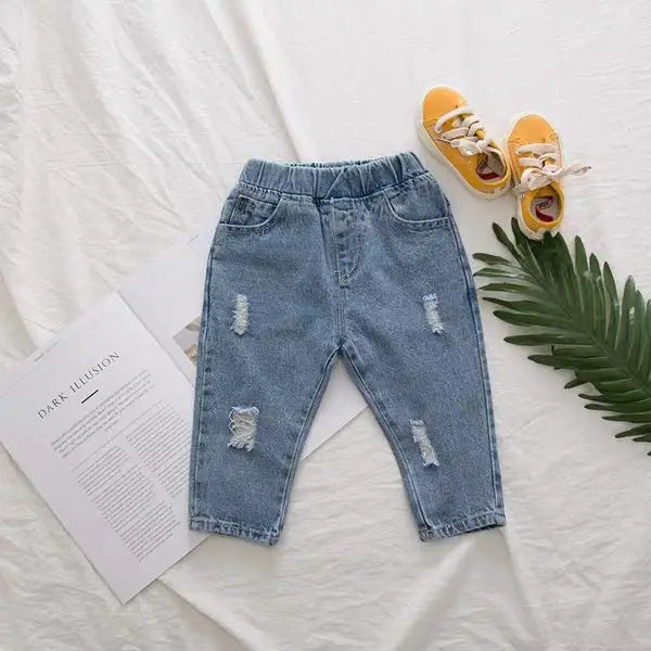 Stylish ripped denim jeans for children, a key piece for toddler fashion autumn